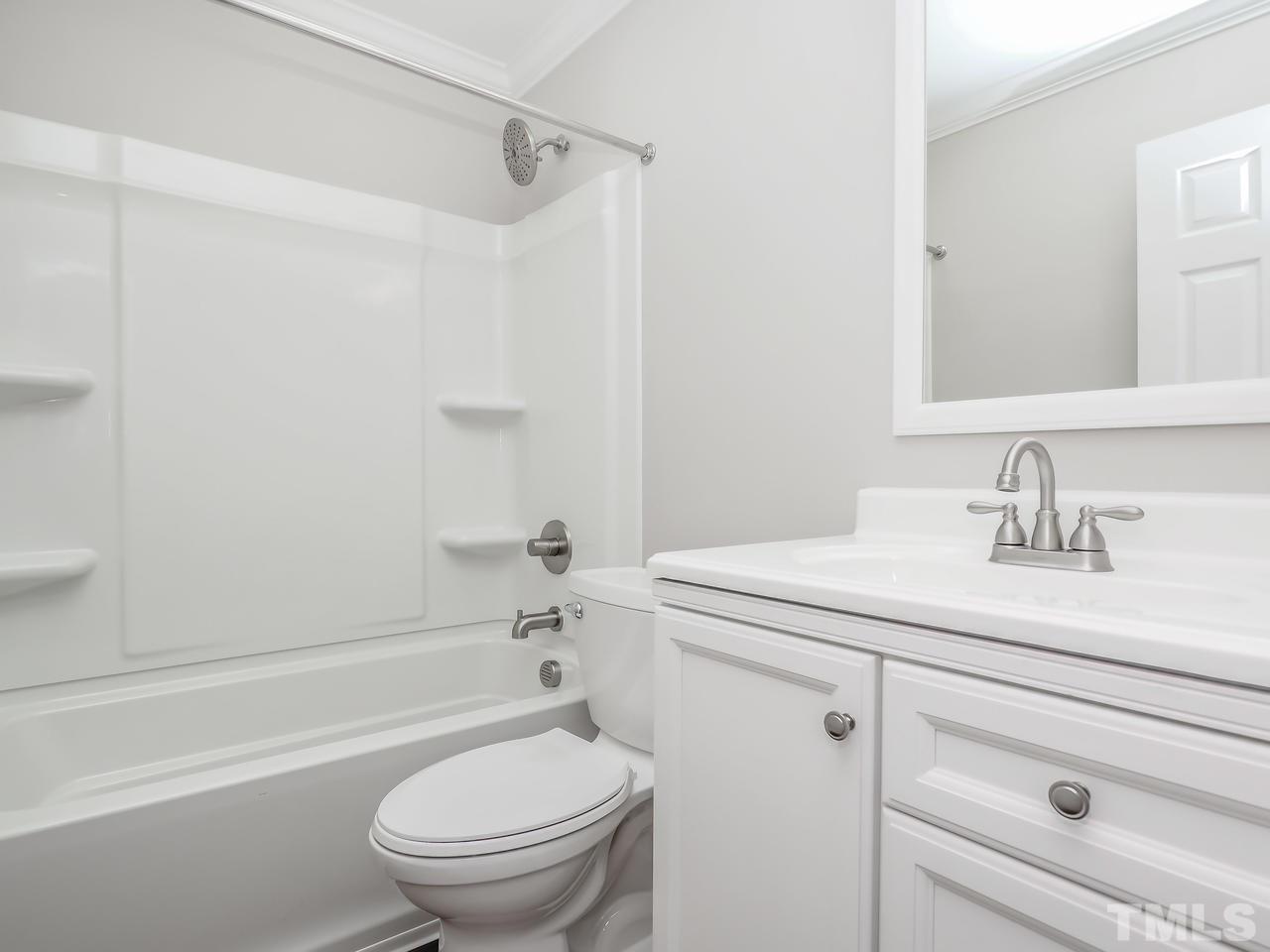 1111 Wyldewood Road Durham, NC 27704 - Photo 6 of 17 a bathroom with a sink toilet vanity and tub