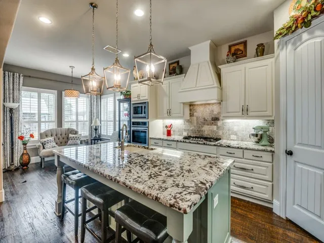 a living room with furniture kitchen view and a large window