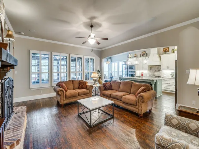 a view of a dining room with furniture a chandelier and wooden floor