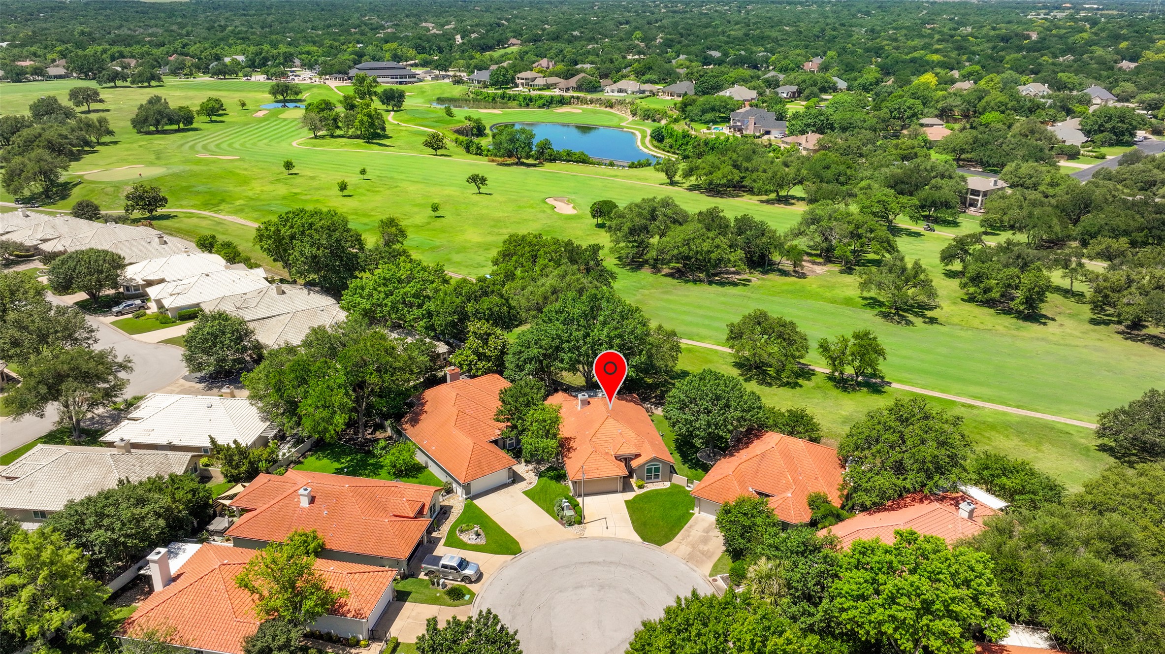 30107 Hamlet Circle Georgetown, TX 78628 - Photo 34 of 40 An aerial perspective showcases a vibrant community bordered by a scenic golf course and a tranquil pond.