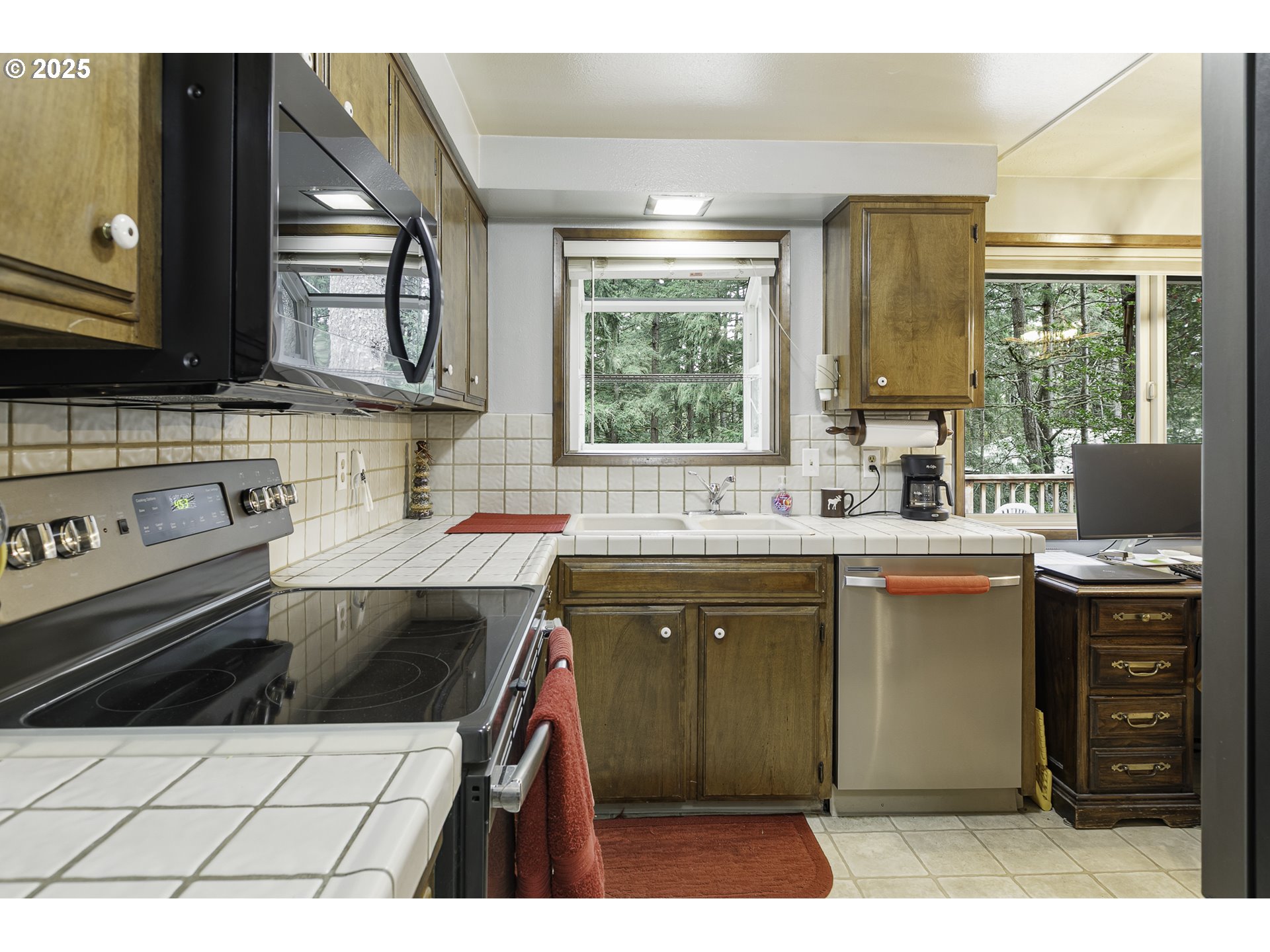 22285 Southeast Ridgeview Drive Damascus, OR 97089 - Photo 11 of 32 a kitchen with a sink a stove and cabinets