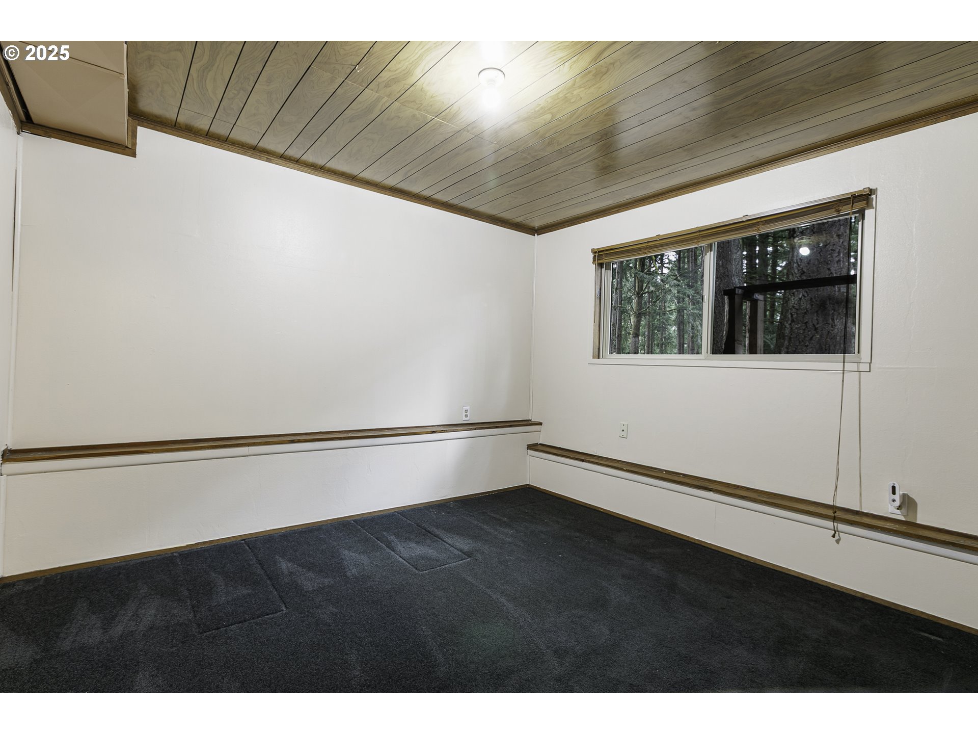 22285 Southeast Ridgeview Drive Damascus, OR 97089 - Photo 16 of 32 a view of an empty room with wooden floor and a window