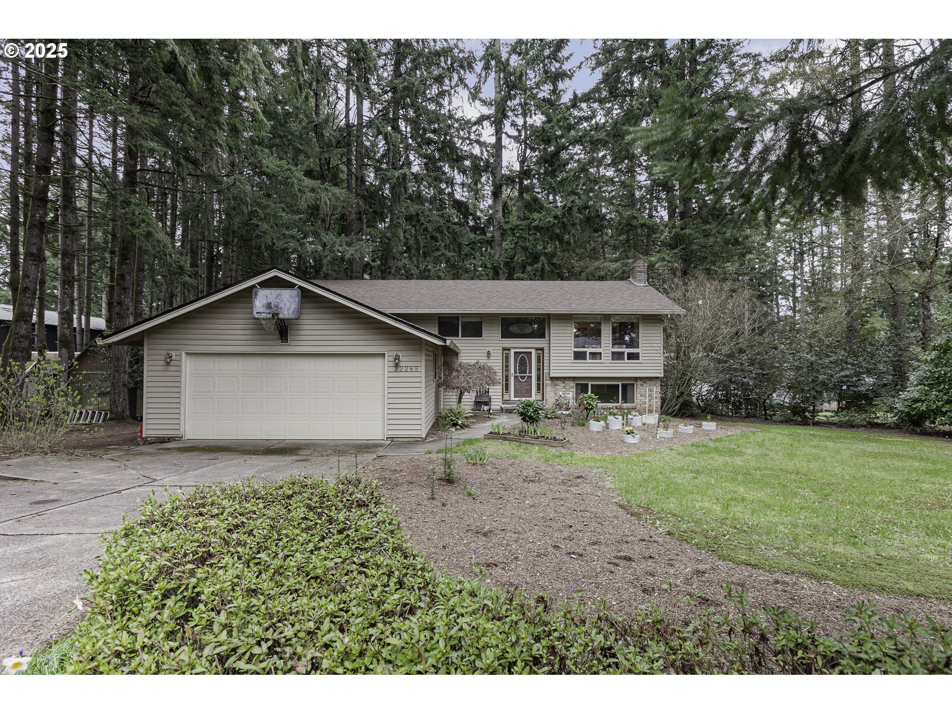 22285 Southeast Ridgeview Drive Damascus, OR 97089 - Photo 2 of 32 a view of house with backyard and garden