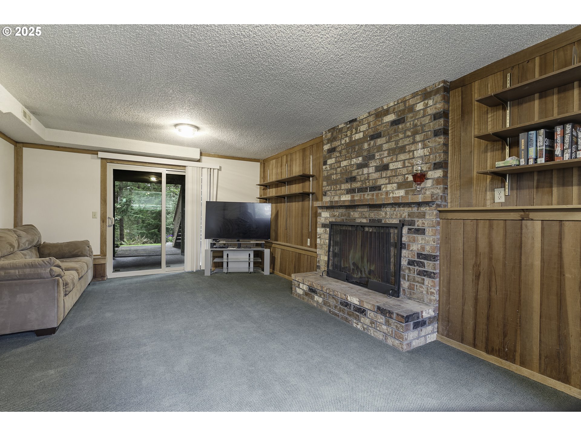 22285 Southeast Ridgeview Drive Damascus, OR 97089 - Photo 23 of 32 a living room with furniture a fireplace and a flat screen tv