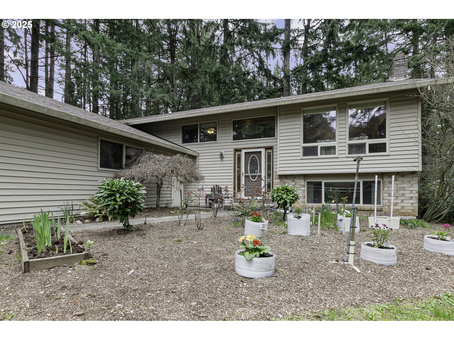 22285 Southeast Ridgeview Drive Damascus, OR 97089 - Photo 4 of 32 a view of a house with a yard and sitting area