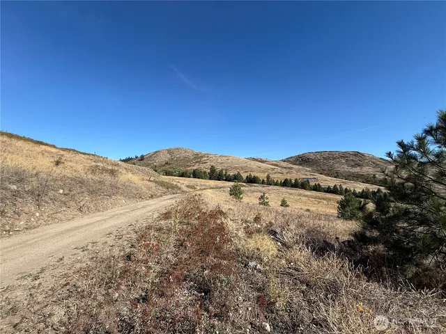 a view of mountain with sunset background