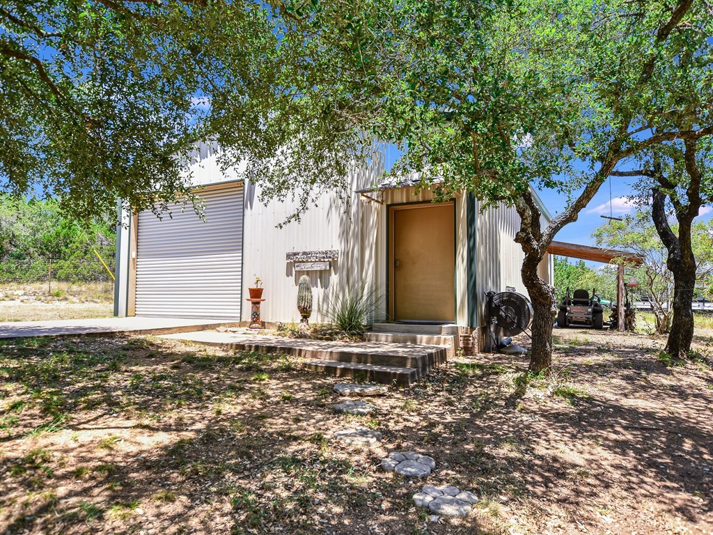 254 Middleton Road Spicewood, TX 78669 - Photo 29 of 32 a backyard of a house with lots of green space