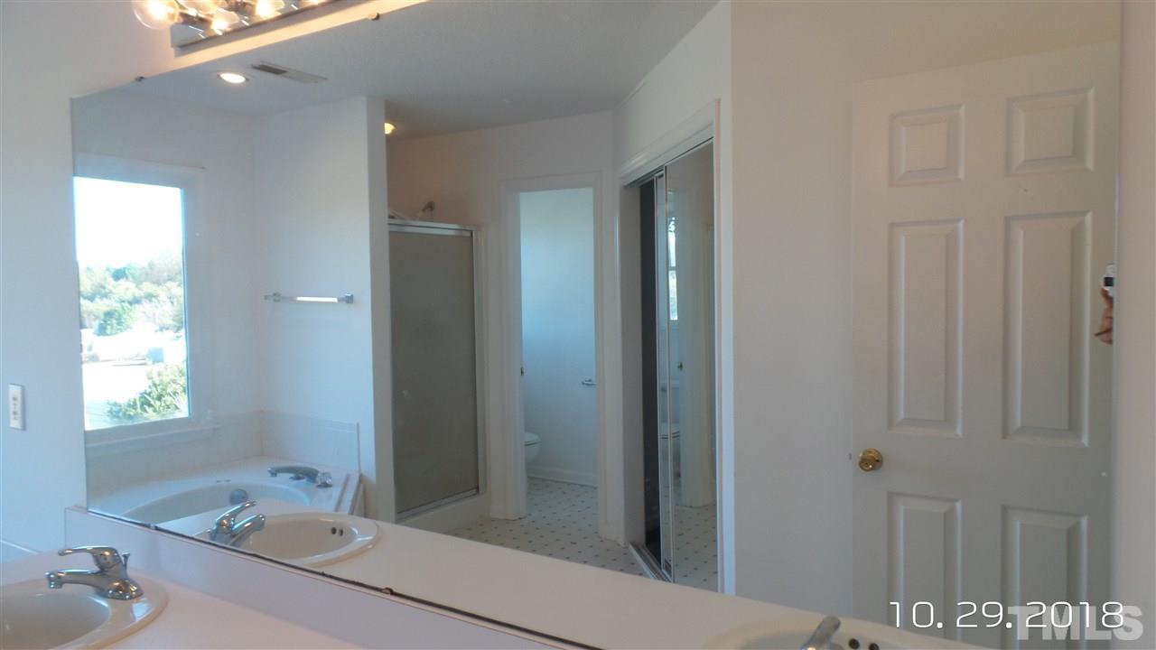 10305 Ten-Ten Road Raleigh, NC 27603 - Photo 14 of 17 a bathroom with a sink and a mirror