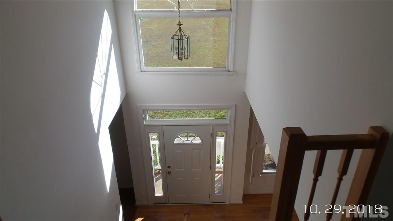 10305 Ten-Ten Road Raleigh, NC 27603 - Photo 9 of 17 a view of a hallway with wooden floor and glass door