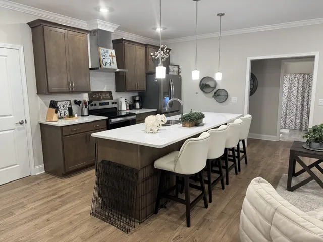 a kitchen with a sink a stove a dining table and chairs