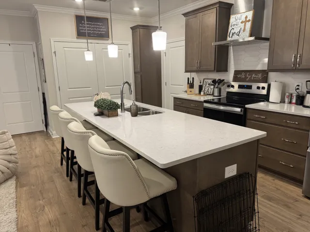 a kitchen with kitchen island a sink table and chairs