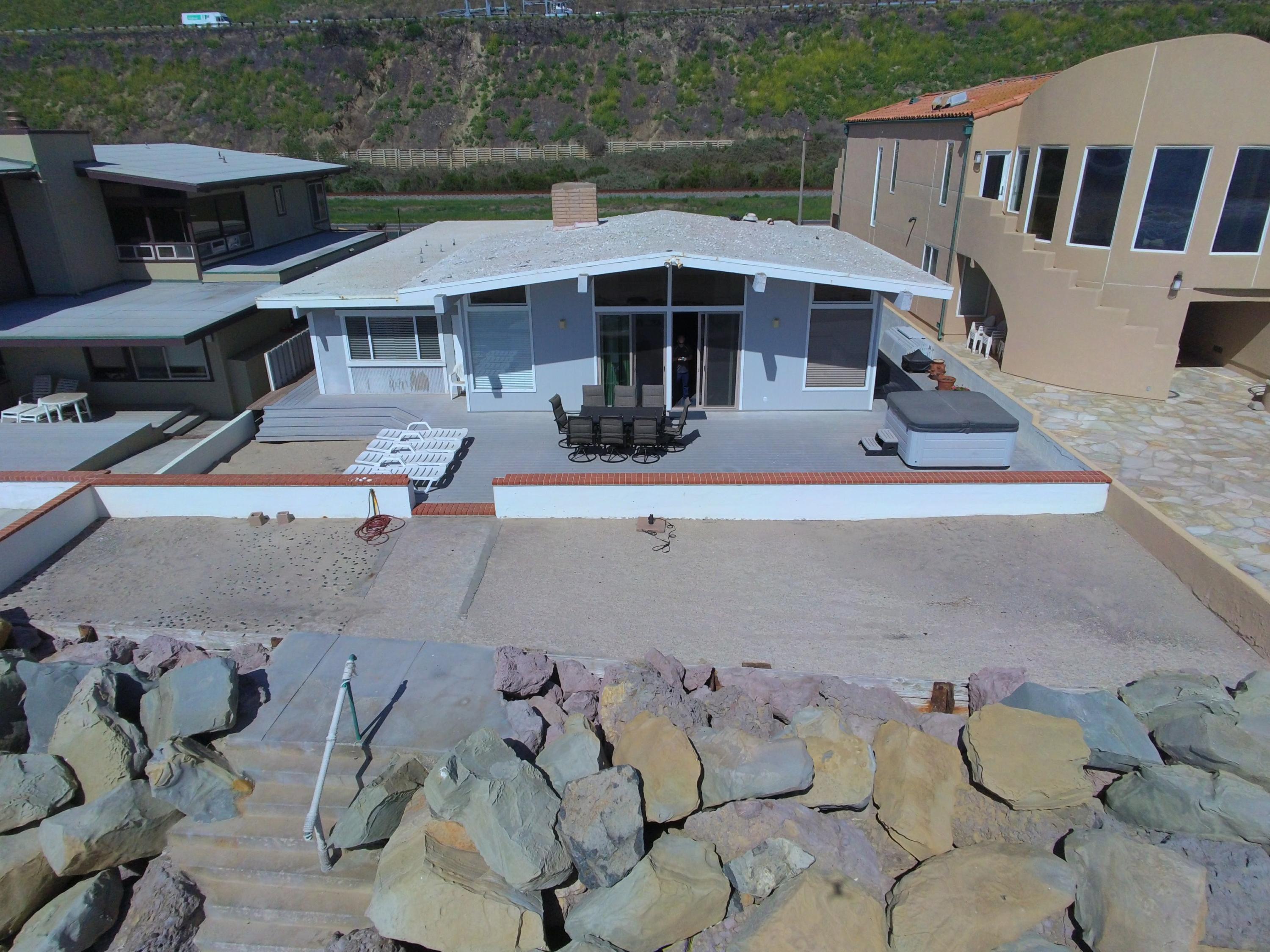 a view of a patio with table and chairs under an umbrella
