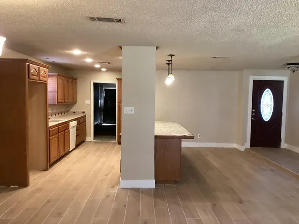 a view of kitchen with sink and refrigerator