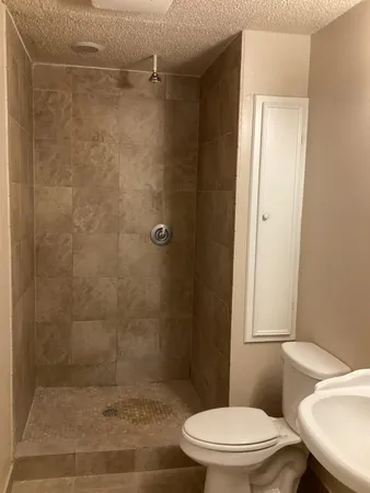 a white toilet sitting next to a bathroom sink