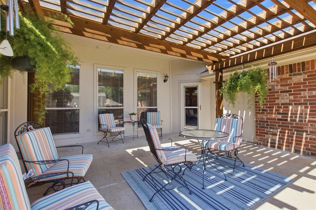 4218 Glistening Spring Rowlett, TX 75088 - Photo 34 of 39 Expansive outdoor patio featuring a wooden pergola, concrete flooring, and brick exterior accents