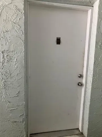 a view of a room with wooden floor and fan