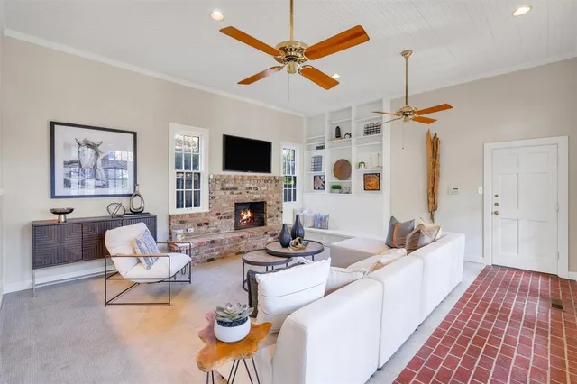 a living room with furniture a fireplace and a flat screen tv