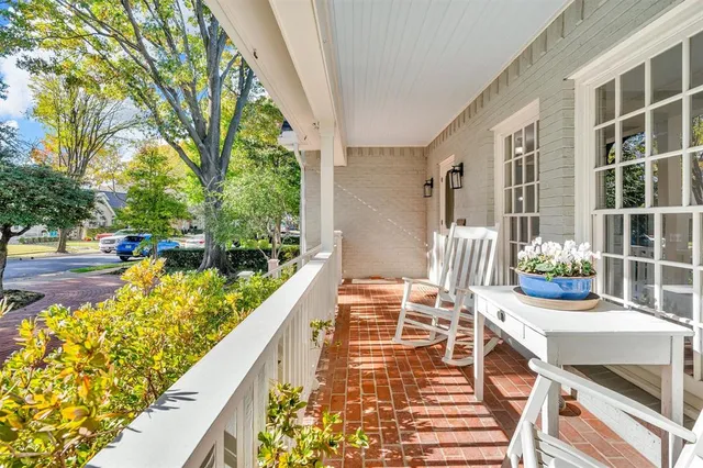 a balcony with table and chairs