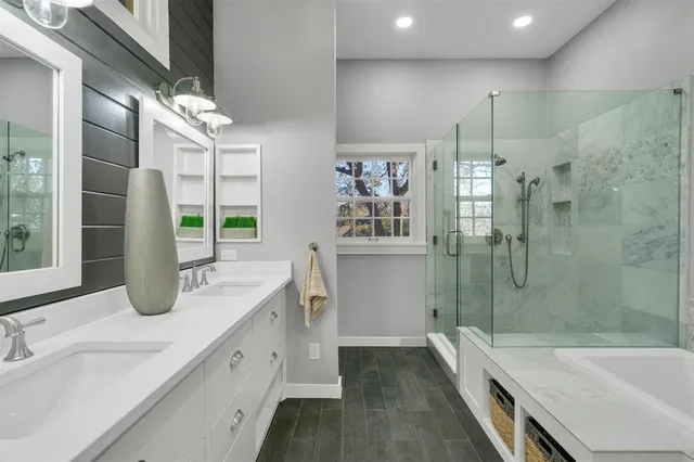 a spacious bathroom with double vanity and a shower