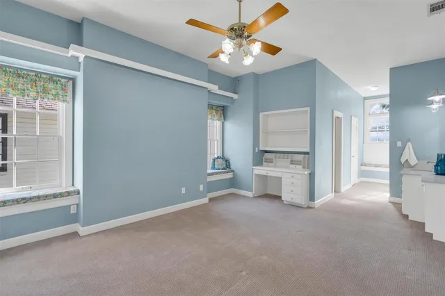 a view of an empty room with a kitchen