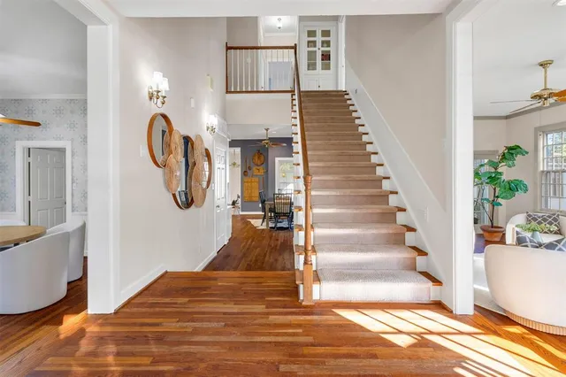 a view of entryway and hall with wooden floor