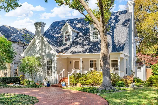 front view of a house with a tree in the background