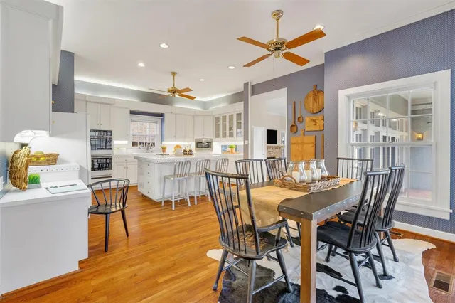 a view of a dining room with furniture and a kitchen view