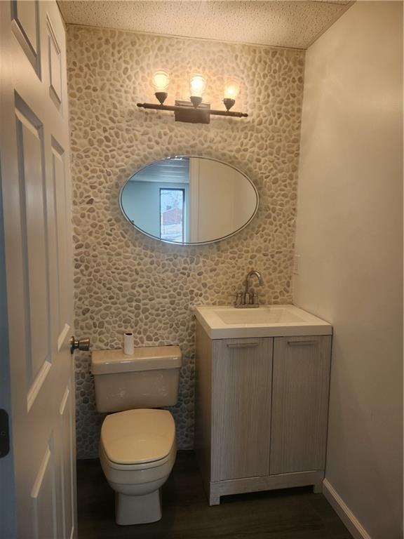 2921 Leechburg Road, Unit 2 Lower Burrell, PA 15068 - Photo 7 of 10 a bathroom with a granite countertop toilet sink and mirror