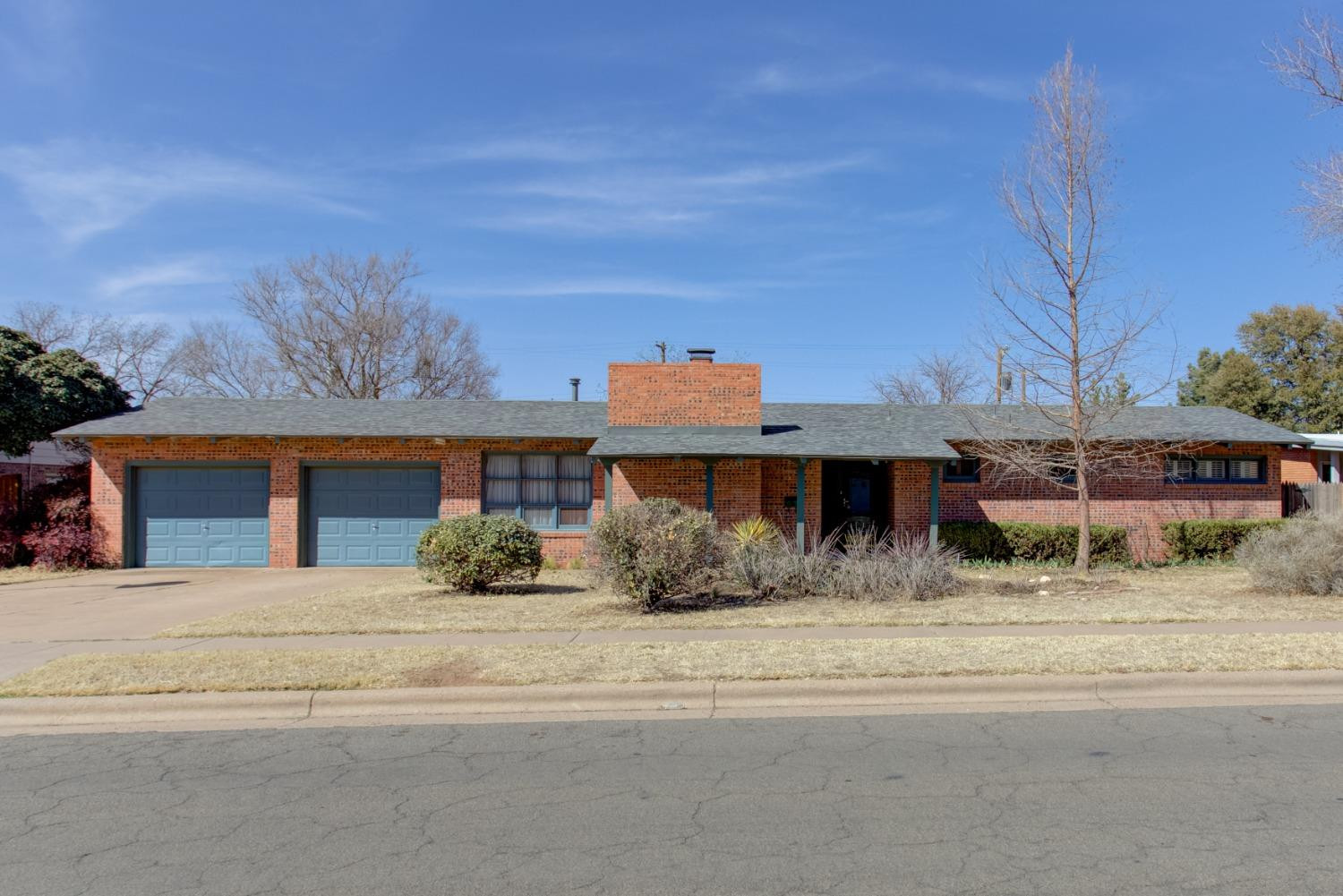 3410 40th Street Lubbock, TX 79413 - Photo 1 of 33 a front view of a house with a yard