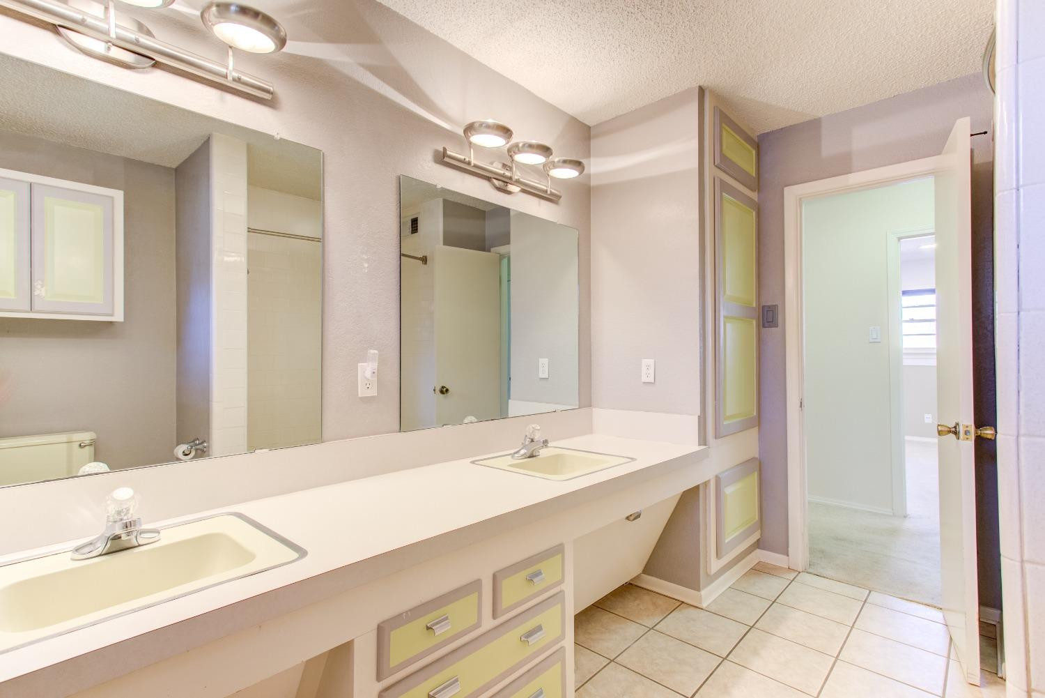 3410 40th Street Lubbock, TX 79413 - Photo 14 of 33 a spacious bathroom with a double vanity sink mirror and double