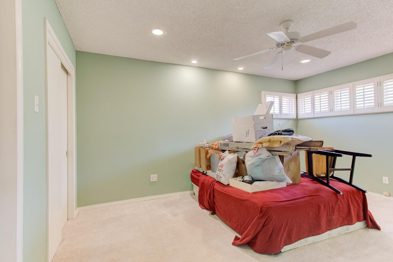 3410 40th Street Lubbock, TX 79413 - Photo 16 of 33 a bed room with furniture and a ceiling fan