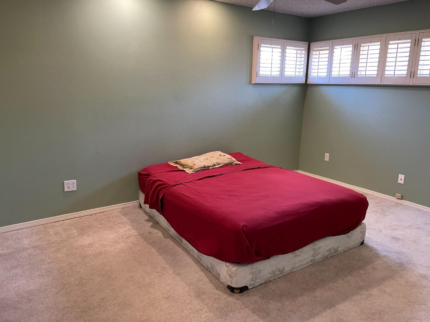 3410 40th Street Lubbock, TX 79413 - Photo 17 of 33 a bed sitting in a bedroom next to a window
