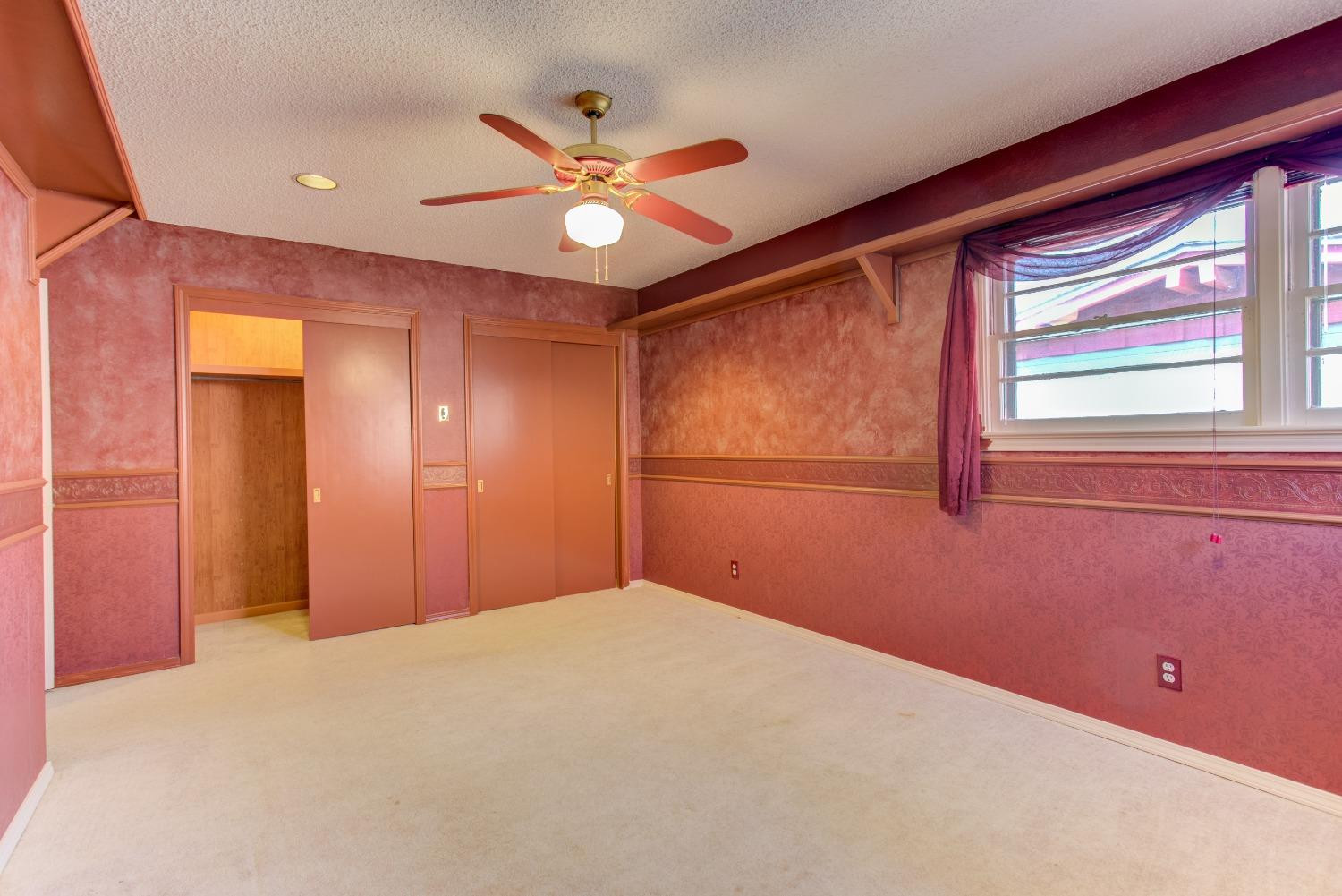 3410 40th Street Lubbock, TX 79413 - Photo 18 of 33 a view of a livingroom with a ceiling fan and window