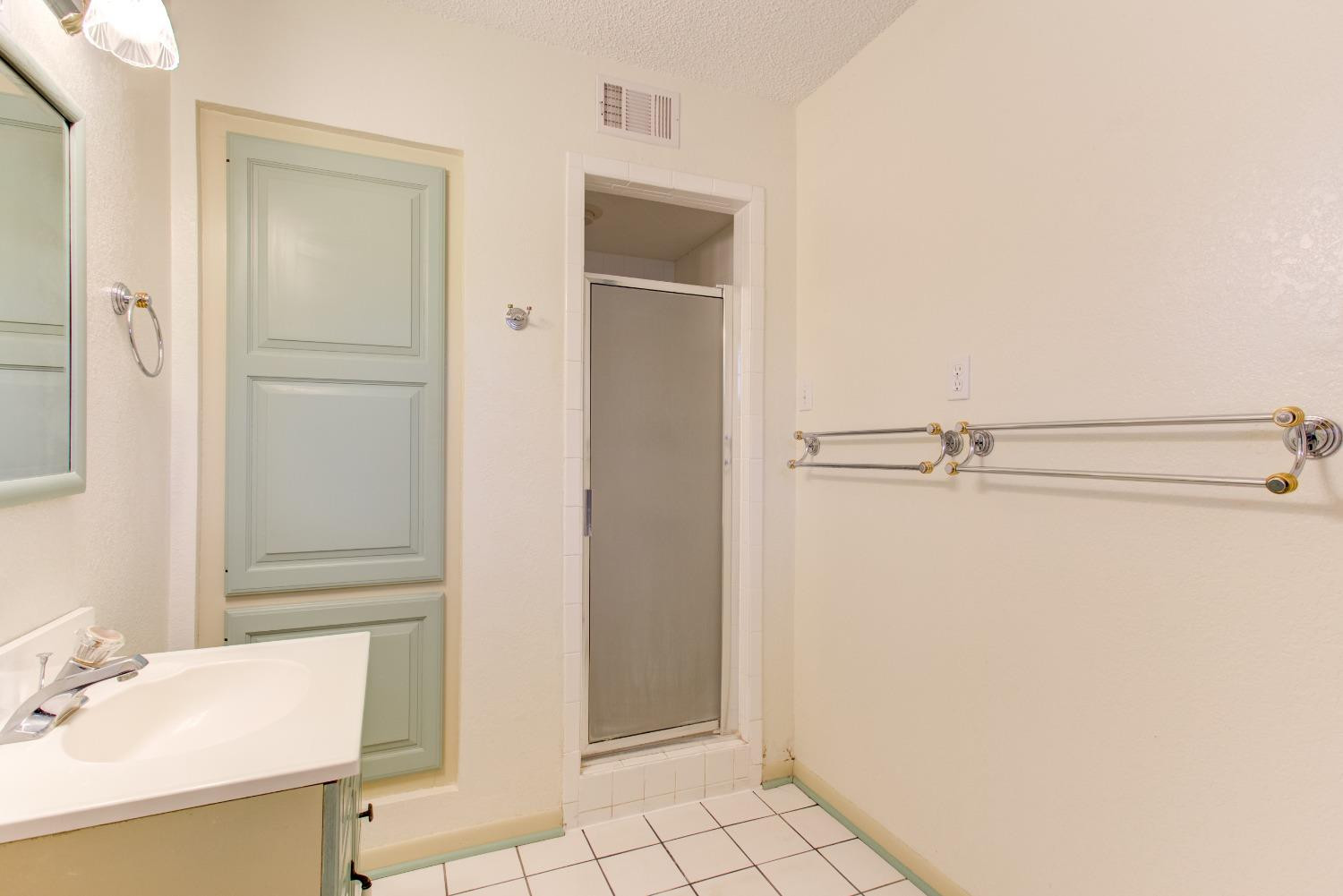 3410 40th Street Lubbock, TX 79413 - Photo 20 of 33 a bathroom with a sink and a mirror