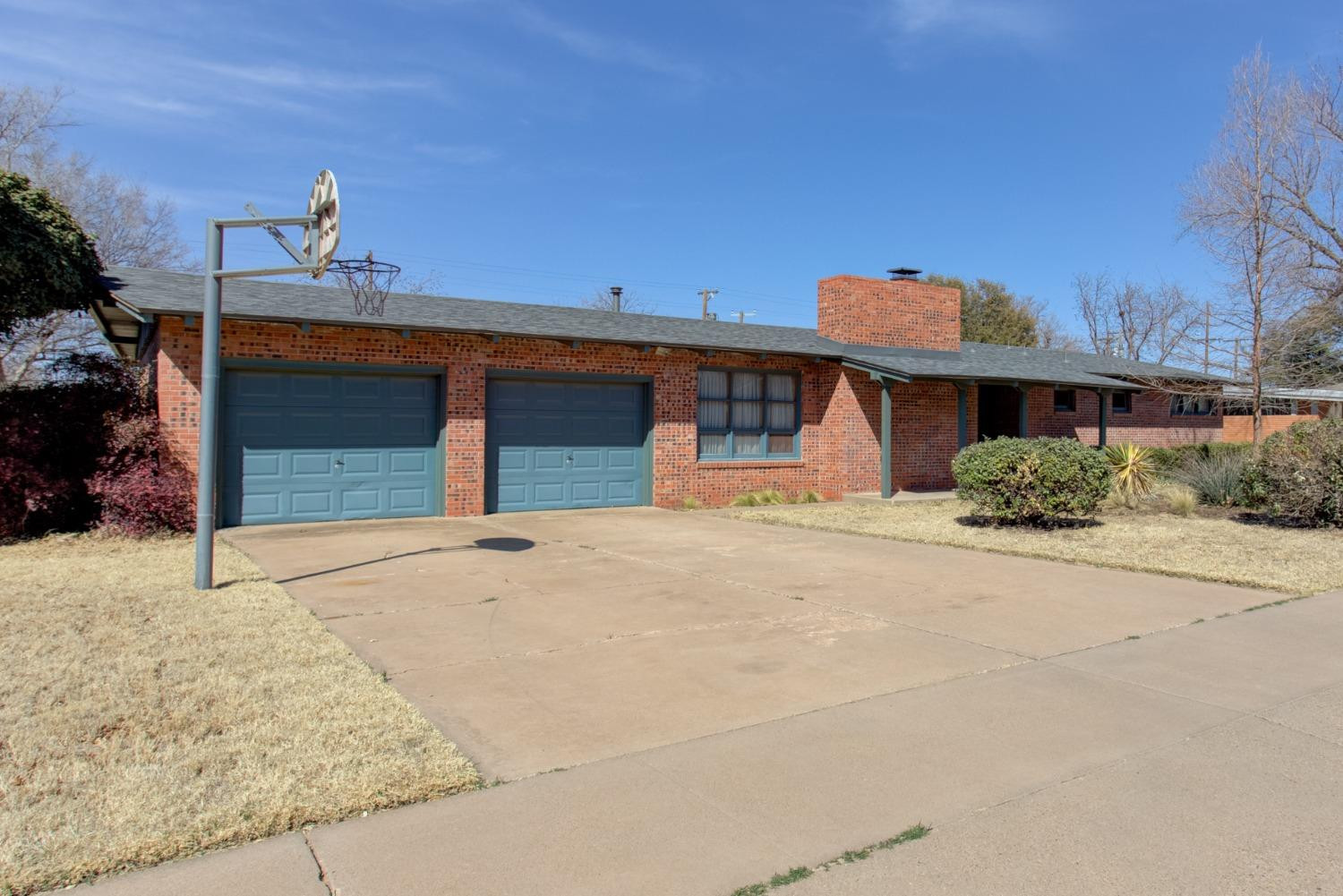 3410 40th Street Lubbock, TX 79413 - Photo 2 of 33 a front view of a house with a yard and garage