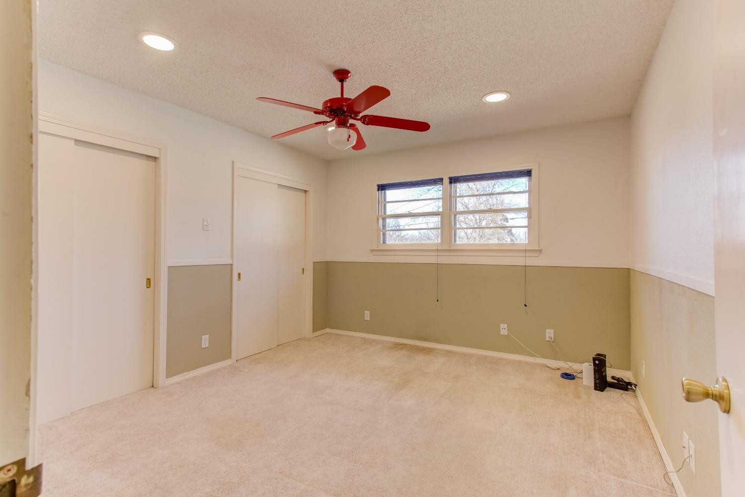 3410 40th Street Lubbock, TX 79413 - Photo 22 of 33 a view of a livingroom with a ceiling fan and window