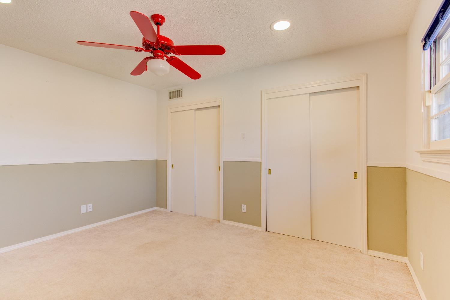 3410 40th Street Lubbock, TX 79413 - Photo 23 of 33 an empty room with a ceiling fan and window