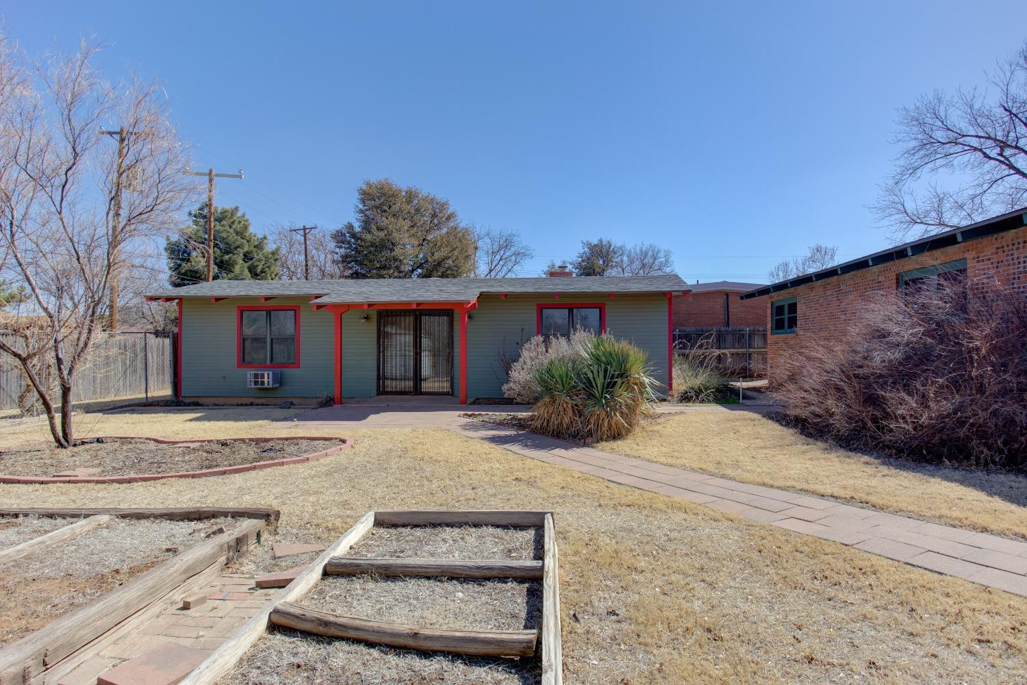 3410 40th Street Lubbock, TX 79413 - Photo 25 of 33 a front view of a house with a yard and garage