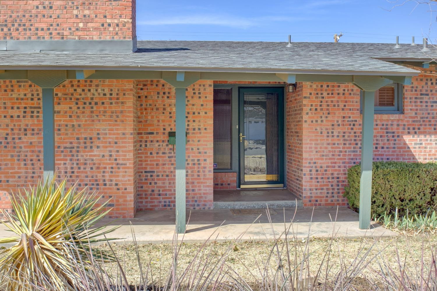 3410 40th Street Lubbock, TX 79413 - Photo 3 of 33 a front view of a house with a garden