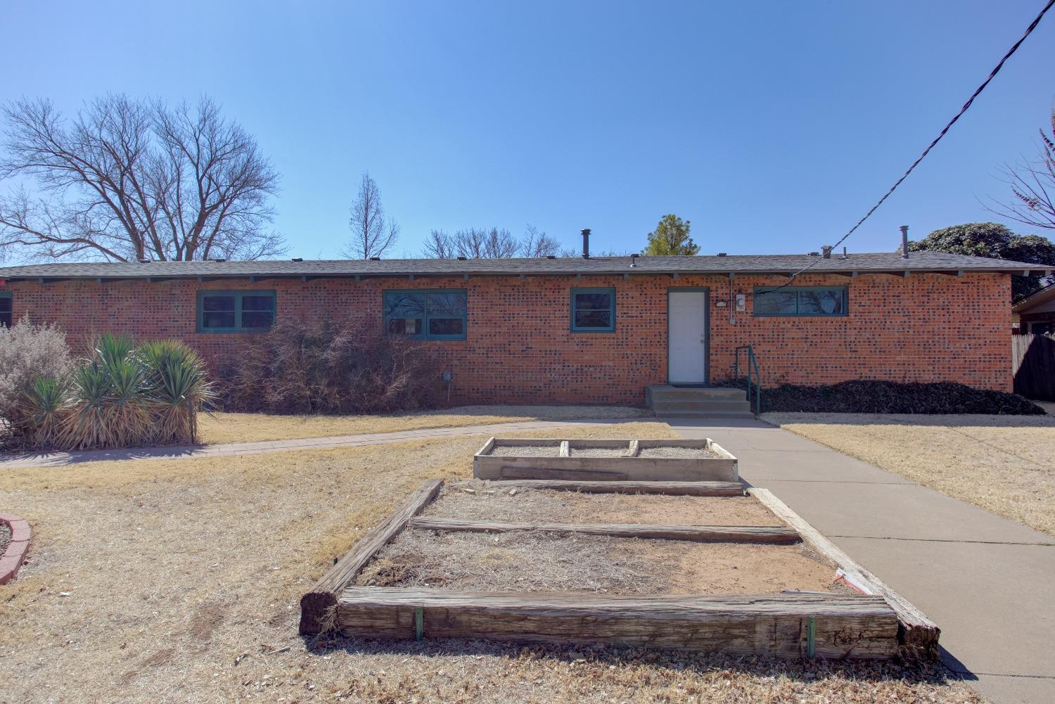 3410 40th Street Lubbock, TX 79413 - Photo 31 of 33 a front view of a house with a yard