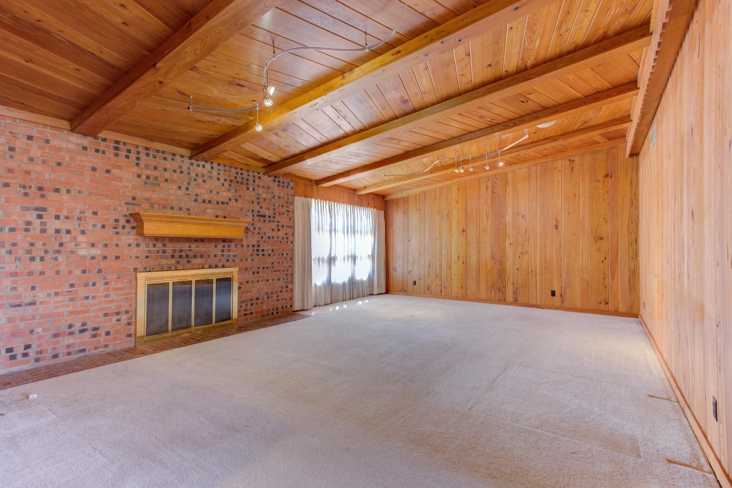 3410 40th Street Lubbock, TX 79413 - Photo 7 of 33 a view of an empty room with a fireplace