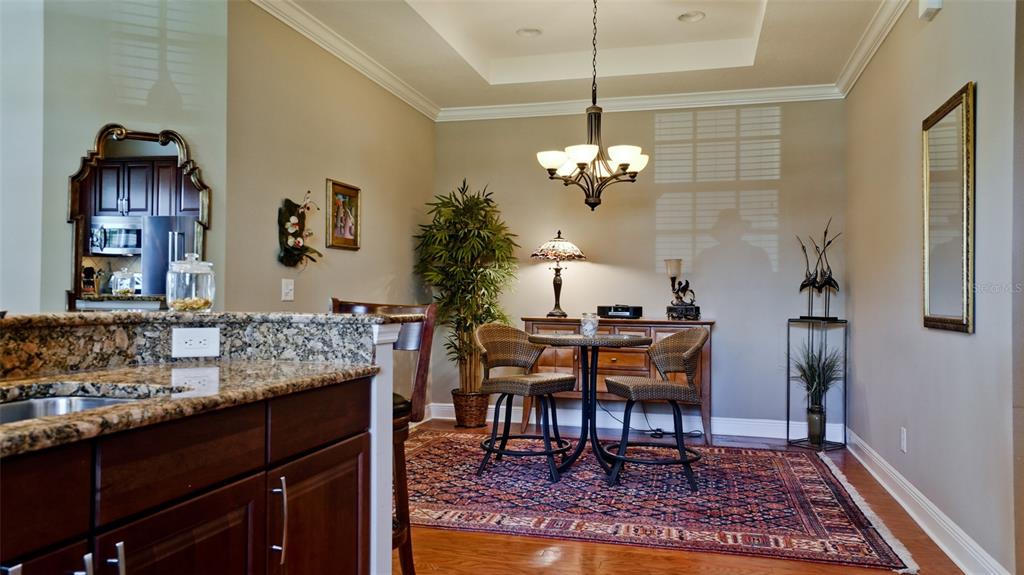 7401 Hamilton Road Bradenton, FL 34209 - Photo 11 of 35 a view of a dining room with furniture and wooden floor