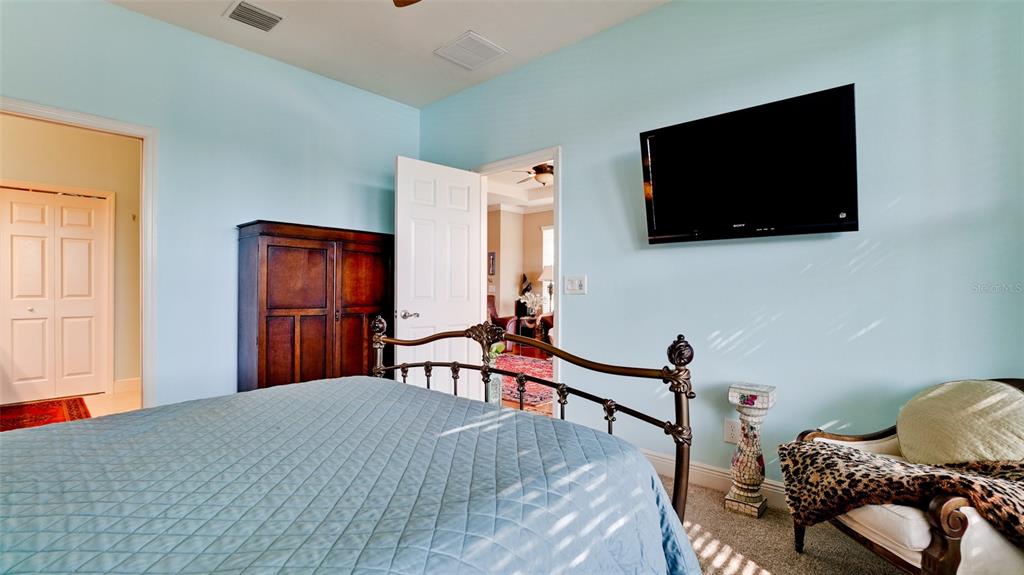 7401 Hamilton Road Bradenton, FL 34209 - Photo 13 of 35 a bedroom with furniture and a flat screen tv