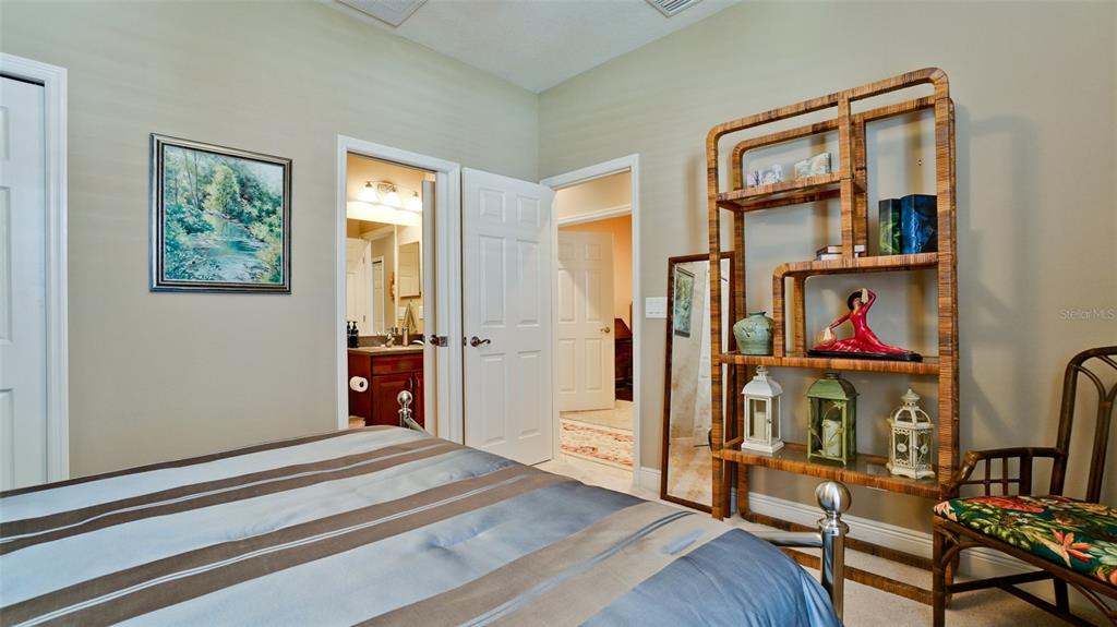 7401 Hamilton Road Bradenton, FL 34209 - Photo 19 of 35 a bedroom with bed and a book shelf