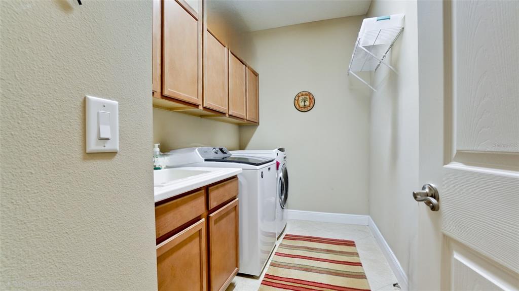 7401 Hamilton Road Bradenton, FL 34209 - Photo 21 of 35 a storage room with wooden floor washer and dryer