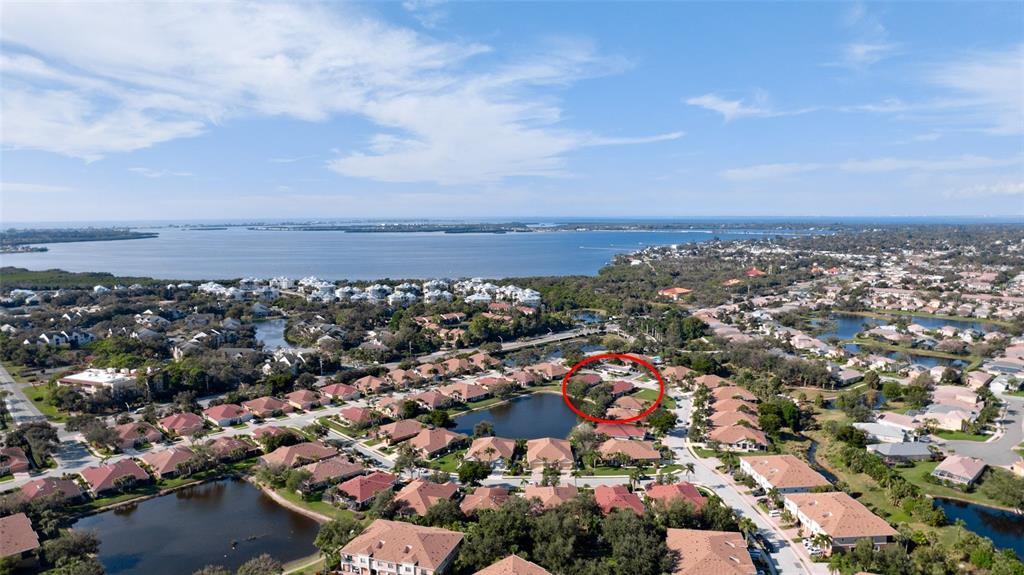 7401 Hamilton Road Bradenton, FL 34209 - Photo 27 of 35 an aerial view of a city with lots of residential buildings and ocean view in back