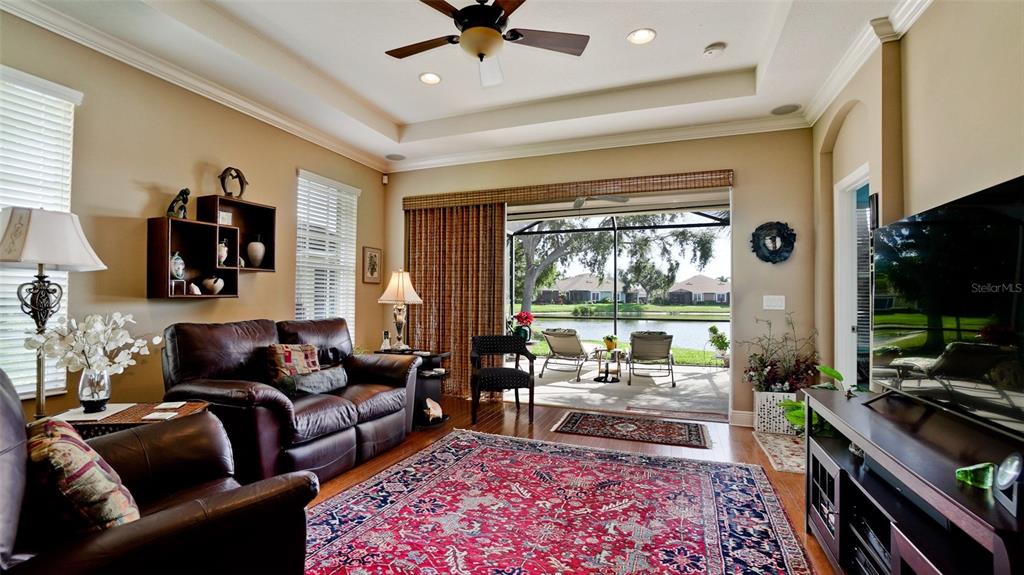 7401 Hamilton Road Bradenton, FL 34209 - Photo 3 of 35 a living room with furniture fireplace and a large window