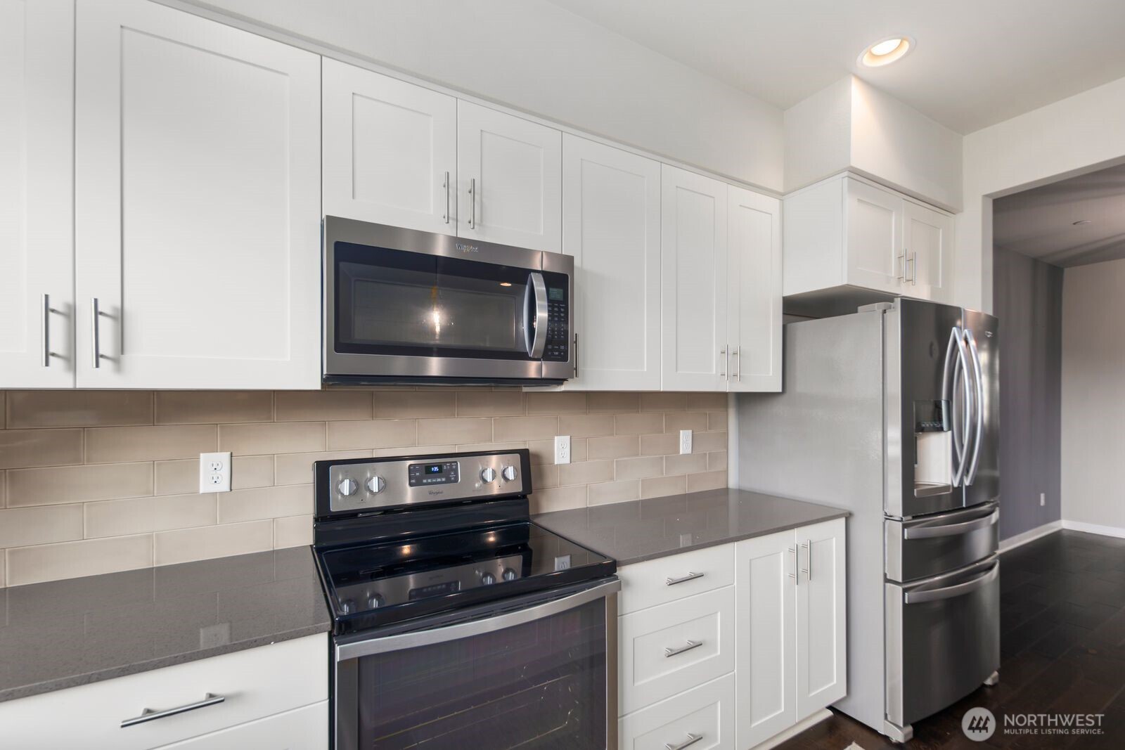 1325 Seattle Hill Road, Unit A2 Bothell, WA 98012 - Photo 11 of 35 a kitchen with stainless steel appliances granite countertop white cabinets a stove a microwave and a refrigerator
