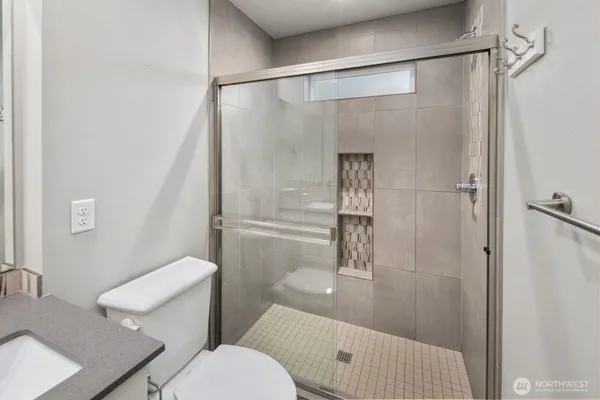 a bathroom with a shower and a toilet