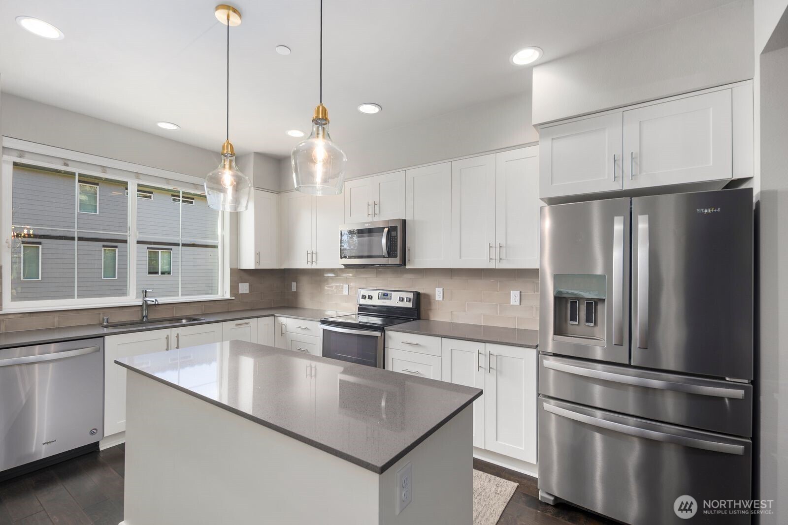 1325 Seattle Hill Road, Unit A2 Bothell, WA 98012 - Photo 5 of 34 a kitchen with stainless steel appliances granite countertop a refrigerator a sink a stove and a refrigerator